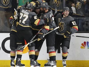 Golden Knights celebrate after left wing James Neal, centre, scored against the  Sharks during the first period of Game 5 of a second round NHL playoff series, Friday, May 4, 2018, in Las Vegas.