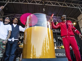 From left to right, Michael Voltaggio, Warren G and Snoop Dogg pose after breaking the world record for the largest paradise cocktail at the Williams Sonoma Culinary stage at the Bottle Rock Napa Valley Music Festival at Napa Valley Expo, Saturday, May 26, 2018, in Napa, Calif. (Amy Harris/Invision/AP)