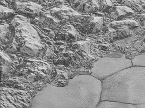 This July 2015 image made by the New Horizons spacecraft shows dunes, small ripples at bottom right, on Pluto's Sputnik Planitia ice plain. At upper left are a series of mountains.