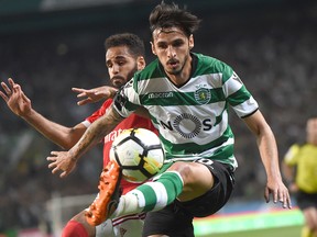 Sporting midfielder Bryan Ruiz (right) challenges Benfica defender Douglas Santos during their Portuguese Liga match at the Jose Alvalade stadium in Lisbon on May 5, 2018. (Getty Images)