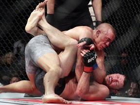 Georges St. Pierre, above, fights Michael Bisping for the middleweight title at UFC 217 Sunday, Nov. 5, 2017, in New York. (AP Photo/Frank Franklin II)