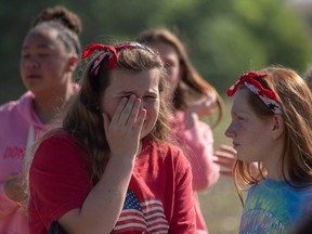 Students react outside Noblesville West Middle School after a shooting at the school in Noblesville, Indiana, on Friday, May 25, 2018.