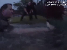 Texas police officers rescue a woman from a sinking vehicle in a suburban Houston lake on Saturday. (Sugar Land Police Department)