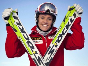 Canadian ski cross team member Georgia Simmerling, of West Vancouver, B.C., poses with her skis at Canada Olympic Park in Calgary, Alta., on Dec. 3, 2012