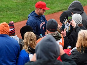 Tim Tebow, playing for the Binghamton Rumble Ponies, signs autographs for fans before the Double-A baseball team's game against the Erie SeaWolves on April 28, 2018