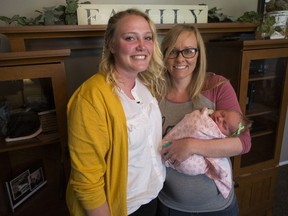 In this Monday, April 30, 2018 photo, Morlie Hayes, 16, and her aunt Laura Creager, both of Eden, pose for photos with Creager's newborn daughter Kayla Faith Creager in Eden, Utah.