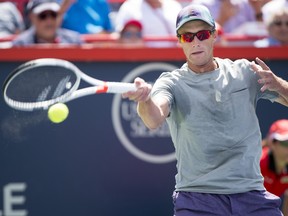 Peter Polansky of Canada returns to Roger Federer of Switzerland during second round of play at the Rogers Cup tennis tournament Wednesday August 9, 2017 in Montreal. (The Canadian Press/Paul Chiasson)