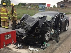 In this Friday, May 11, 2018, file photo released by the South Jordan Police Department shows a traffic collision involving a Tesla Model S sedan with a Fire Department mechanic truck stopped at a red light in South Jordan, Utah.