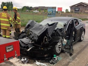 In this Friday, May 11, 2018, file photo released by the South Jordan Police Department shows a traffic collision involving a Tesla Model S sedan with a Fire Department mechanic truck stopped at a red light in South Jordan, Utah.