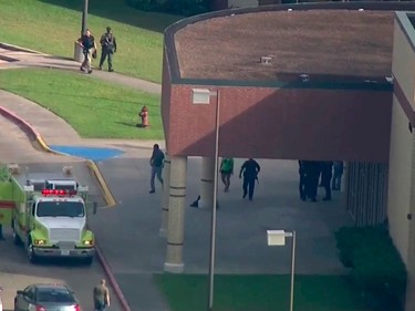 In this image taken from video law enforcement officers respond to a high school near Houston after an active shooter was reported on campus, Friday, May 18, 2018, in Santa Fe, Texas. The Santa Fe school district issued an alert Friday morning saying Santa Fe High School has been placed on lockdown.