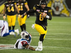 Hamilton Tiger-Cats quarterback Jeremiah Masoli scrambles while chased by Montreal Alouettes defensive end John Bowman in Hamilton, Ont., in this Nov. 3, 2017 file photo.