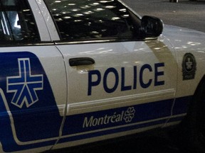 MONTREAL, QUE.: JULY 18, 2012 -- Two police cars remain on scene  outside Notre Dame Basilica in Old Montreal after an armed man was present earlier in the evening  on Wednesday, July 18,  2012. (THE GAZETTE / Tijana Martin) **CROPPED  FOR USE AS GENERIC BREAKING NEWS NIGHT MONTREAL POLICE FILE ART **