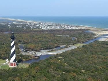 FILE - This 2003, file photo, shows the Cape Hatteras Lighthouse overlooking the Atlantic Ocean and the village of Buxton, N.C. Lighthouse Beach in Buxton is No. 6 on the list of best beaches for the summer of 2018 compiled by Stephen Leatherman, also known as Dr. Beach, a professor at Florida International University.