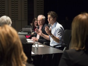 Prime Minister Justin Trudeau meets with G7 Sherpas, in preparation for the summit, Thursday, May 24, 2018 in Baie-St-Paul, Que. Deputy Minister for the G7 Summit and Personal Representative of the Prime Minister Peter Boehm, behind, looks on. THE CANADIAN PRESS/Jacques Boissinot