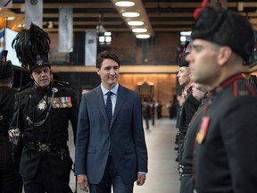 Prime Minister Justin Trudeau inspects the troops of the Voltigeurs de Quebec on Saturday, May 12, 2018 in Quebec City.
