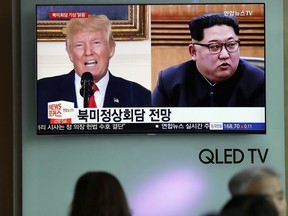 In this May 11, 2018, file photo, people watch a TV screen showing file footage of U.S. President Donald Trump, left, and North Korean leader Kim Jong Un, right, during a news program at the Seoul Railway Station in Seoul, South Korea.