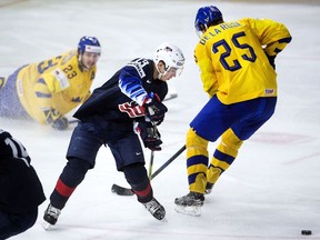 Johnny Gaudreau of Team USA knocks puck off stick of Team Sweden’s Jacob De La Rose during semifinal game at the IIHF World Championship in Copenhagen, Denmark on May 19, 2018.