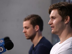 Jacob Trouba (right) answers a question while Josh Morrissey waits during the Winnipeg Jets final media availability at Bell MTS Place in Winnipeg on Tues., May 22, 2018. Kevin King/Winnipeg Sun/Postmedia Network