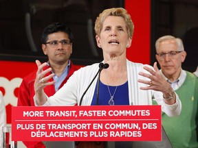 Ontario Liberal Leader Kathleen Wynne speaks in front of the O-Train at a campaign stop in Ottawa on Thursday, May 17, 2018.