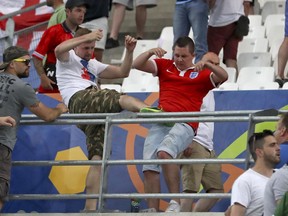 In this file photo taken on Saturday, June 11, 2016, clashes break out in the stands during the Euro 2016 match between England and Russia, at the Velodrome stadium in Marseille, France.