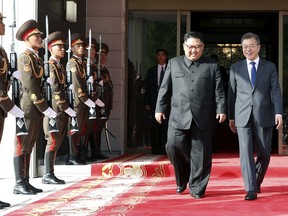 In this May 26, 2018 photo provided on May 27, 2018, by South Korea Presidential Blue House via Yonhap News Agency, North Korean leader Kim Jong Un, center left, and South Korean President Moon Jae-in, right, walk after their meeting at the northern side of Panmunjom in North Korea. Kim and Moon met Saturday, May 26, for the second time in a month, exchanging a huge bear hug and broad smiles in a surprise summit at a border village to discuss Kim's potential meeting with U.S. President Donald Trump and ways to follow through on the peace initiatives of the rivals' earlier summit. (South Korea Presidential Blue House/Yonhap via AP)