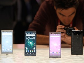 A man takes pioctures of Sony Xperia XZ2 mobilephones at the Mobile World Congress (MWC), the world's biggest mobile fair, on Feb. 26, 2018 in Barcelona.