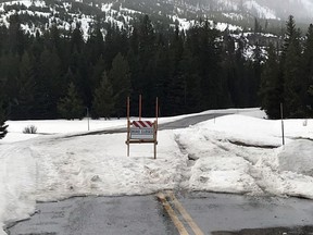 This photo provided by the Parks County Sheriff's Office, shows tire tracks in snow where two men drove past a road-closed sign in northwest Wyoming on Tuesday, May 1, 2018, while trying to get to Yellowstone National Park.