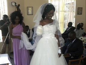 In this photo taken on Saturday, May, 5, 2018, Zanele Ndlovu walks down the aisle on her wedding day at a hospital Chapel in Bulawayo, Zimbabwe. (AP Photo)