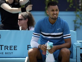 Australia's Nick Kyrgios looks on during a break in his semifinal tennis match against Croatia's Marin Cilic at the Queen's Club tennis tournament in London, Saturday, June 23, 2018. (AP Photo/Tim Ireland)