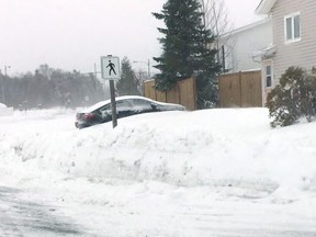 Snow piles up on a street in Gander, N.L. on Thursday, May 24, 2018. (The Canadian Press/HO-Randy Conners)