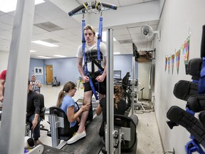 Ryan Straschnitzki on the Therastride machine at Shriners Hospital for Children in Philadelphia on Tuesday June 26, 2018. Itís a body weight-supported manual treadmill training system that allows people with paralysis to walk. Leah Hennel/Postmedia