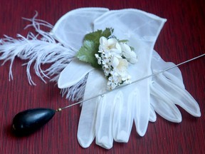 Historical lady's gloves and a hatpin sits under glass on the main floor of the seniors' centre on Feb. 10, 2017. (Julie Oliver/Postmedia)
