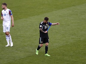 Argentina's Lionel Messi walks from the field following their match against Iceland on Saturday. (AP PHOTO)