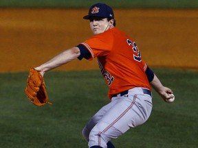 Auburn pitcher Casey Mize throwing during the first inning of a Southeastern Conference tournament NCAA college baseball game against Texas A&M in Hoover, Ala. on May 24, 2018. (AP Photo/Butch Dill)