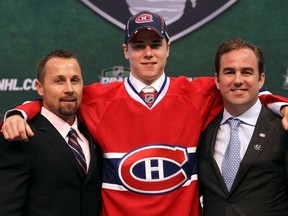 Head scout Trevor Timmins (left) and team owner/president Geoff Molson pose with defenceman Nathan Beaulieu after selecting him in the first round (17th overall) at the 2011 NHL Draft in St. Paul, Minn.