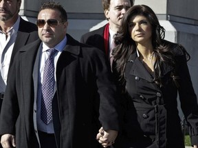 Teresa Giudice and her husband Giuseppe 'Joe' Giudice (L) leave Newark federal court on November 20, 2013 in Newark, New Jersey. The two of the stars of the Bravo television show 'The Real Housewives of New Jersey' are appearing in court to face additional charges of bank fraud and loan application fraud in addition to original charges of defrauding lenders, illegally obtaining mortgages and other loans as well as allegedly hiding assets and income during a bankruptcy case.