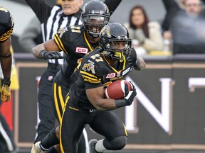 Delvin Breaux #27 of the Hamilton Tiger-Cats takes off with a fumble recovery against the Montreal Alouettes in the CFL football Eastern Conference Final at Tim Hortons Field on November 23, 2014 in Hamilton, Ontario, Canada. (Claus Andersen/Getty Images)