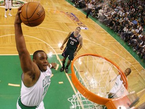 Glen Davis of the Boston Celtics dunks the ball as Al Horford of the Atlanta Hawks looks on during Game Seven of the Eastern Conference Quarterfinals during the 2008 NBA Playoffs on May 4, 2008 at the TD Garden in Boston, Massachusetts. (Elsa/Getty Images)