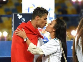 Cristiano Ronaldo of Real Madrid celebrates his sides victory with his girlfriend Georgina Rodriguez following winning the UEFA Champions League Final between Real Madrid and Liverpool at NSC Olimpiyskiy Stadium on May 26, 2018 in Kiev, Ukraine.