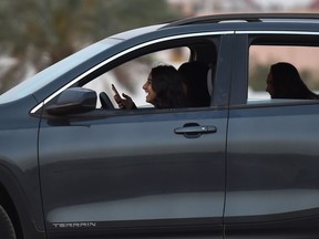 A Saudi woman test-drives a car during an automotive exhibition for women in the capital Riyadh on May 13, 2018. (Fayez Nureldine/Getty Images)