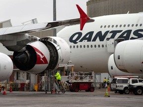 This picture taken on June 1, 2018 shows ground staff preparing a Qantas Airbus A380 aircraft for flight at the Sydney International airport. (File Photo, AFP/Getty Images)