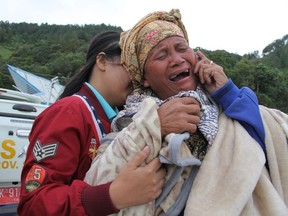 A woman cries as she finds out her family is one of missing passengers at Lake Toba ferry port in the province of North Sumatra, after a boat overturned.  Search and rescue teams are racing against time to search for 65 people after a boat capsized in Indonesia, an official from the disaster agency said.