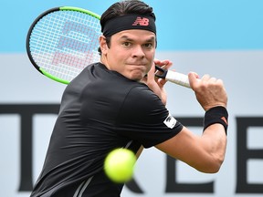 Canada's Milos Raonic returns to India's Yuki Bhambri during their first round men's singles match at the ATP Queen's Club Championships tennis tournament in west London on June 19, 2018. (Glyn Kirk/Getty Images)