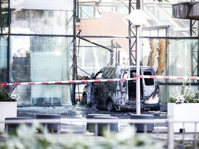 A picture taken on June 26, 2018 on Basisweg street in Amsterdam, shows a van that crashed through the front door of the building that houses newspaper De Telegraaf.   The vehicle went up in flames, causing a large amount of damage to the building. No one was injured.