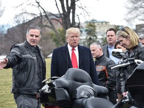 In this file photo taken on February 2, 2017, U.S. President Donald Trump speaks with Harley Davidson CEO Matthew Levatich (L) as he greets Harley Davidson executives and union representatives on the South Lawn of the White House in Washington, D.C, prior to a luncheon with them. (NICHOLAS KAMM/AFP/Getty Images)