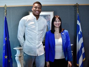 NBA All-Star and Milwaukee Bucks forward Giannis Antetokounmpo and Greek Tourism Minister Elena Kountoura pose for a picture during a press conference to present a new ad campaign featuring the star player, released by the Greek Tourism Ministry, in Athens on June 29, 2018. (Louisa Gouliamaki/Getty Images)