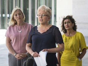 Former BBC China Editor Carrie Gracie, centre, speaks to the media alongside BBC journalists Martine Croxall, left and Razia Iqbal, outside BBC New Broadcasting House, after Gracie resolved her equal-pay dispute with the BBC, in London, Friday June 29, 2018.