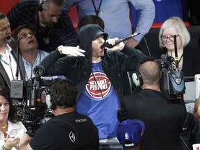 In this Oct. 18, 2017, file photo, Eminem yells to the crowd before the start of an NBA game between the Detroit Pistons and the Charlotte Hornets in Detroit.