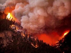 In this photo taken Wednesday, June 6, 2018, the 416 Fire burns down Hermosa Cliffs above U.S. Highway 550 on the southeast side of the fire near Hermosa, Colo.