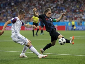 Croatia's Luka Modric, right, duels for the ball with Iceland's Johann Gudmundsson during the 2018 World Cup in the Rostov Arena in Rostov-on-Don, Russia, Tuesday, June 26, 2018.